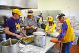 Members of the Lemoore Lions Club help prepare Thursday's Thanksgiving meal, a tradition that began 18 years ago and continues in 2018.